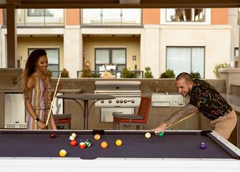 Couple playing pool indoor at The Residences at Galleria, Kansas, 66211